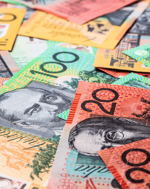 Small hero image for the creatives guide to money management workshop. A high-angle, close-up shot of a pile of Australian currency, prominently featuring the colorful $20, $50, and $100 banknotes.